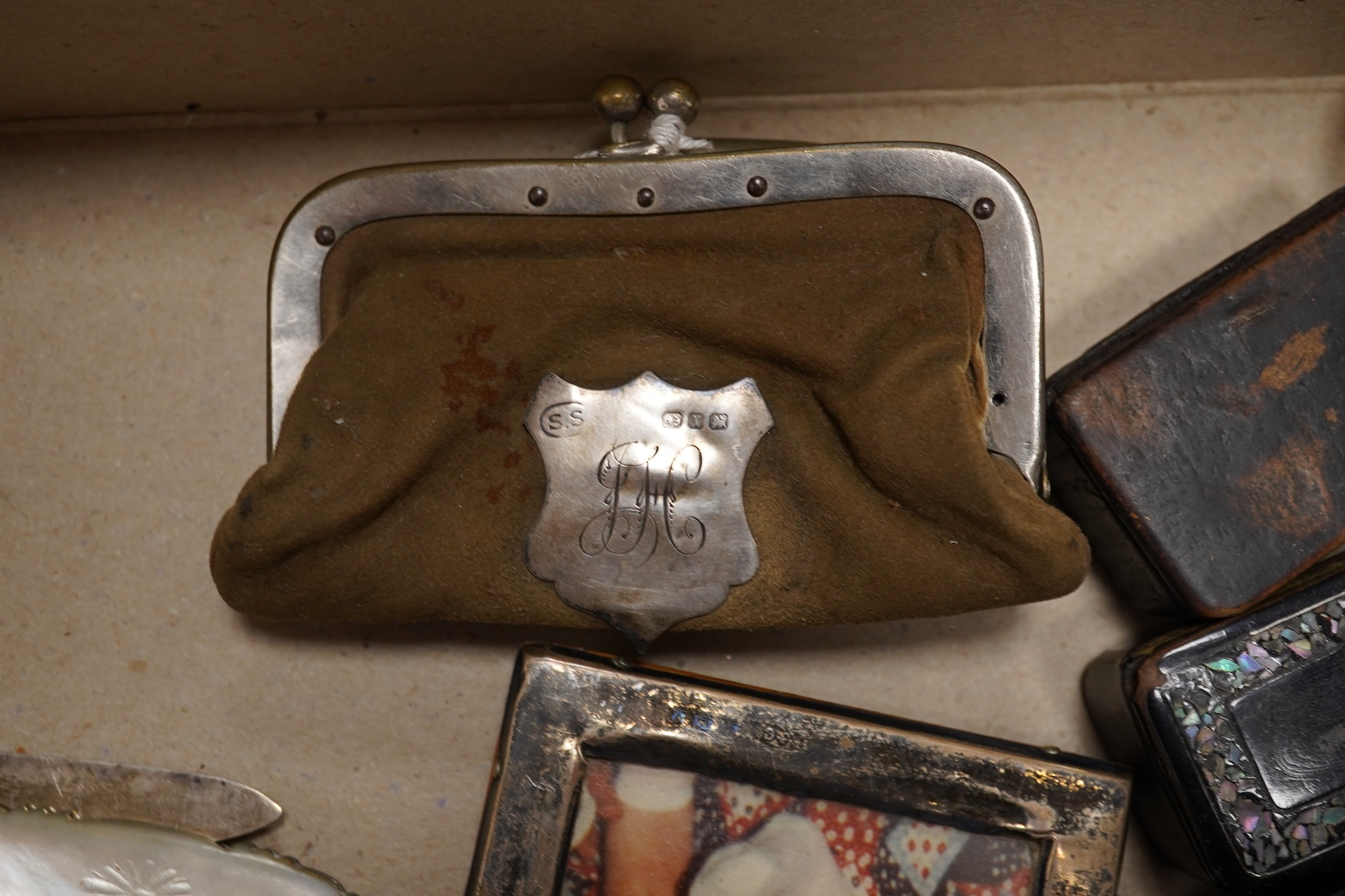 A collection of objects of vertu including snuff boxes, a pair of miniature oval trays, a silver mounted clock and photo frame, etc.